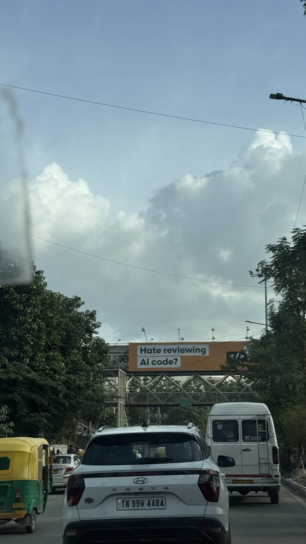 an ai coding billboard above blr traffic